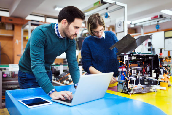 adult students work in a robotics lab